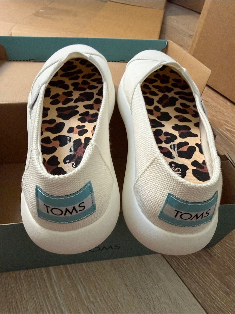 TOMS Cream Canvas Slip-Ons with Teal Logo and Leopard Insole